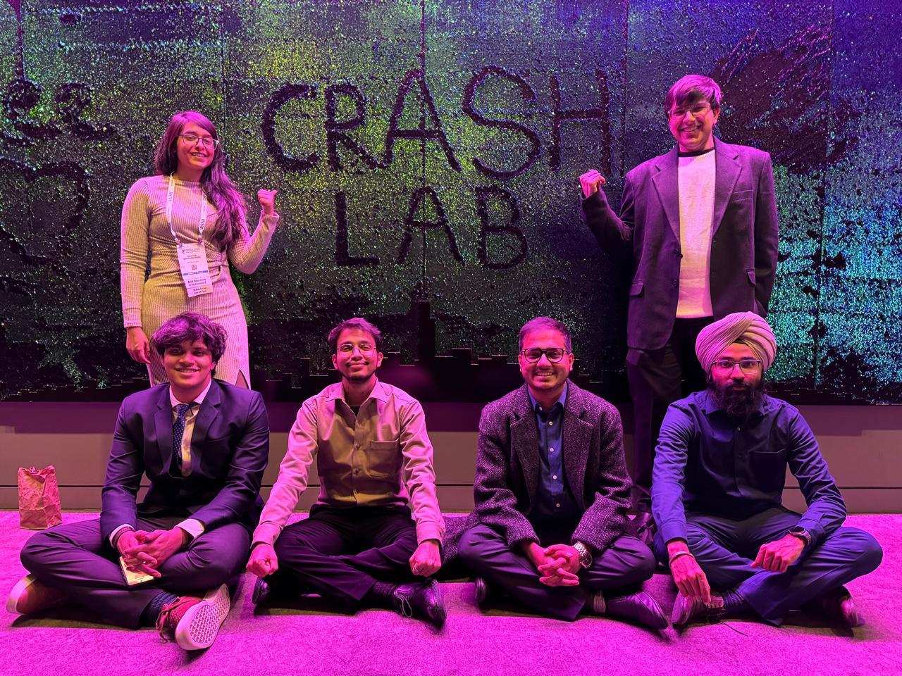 CRASH Lab team in front of the CRASH LAB backdrop.